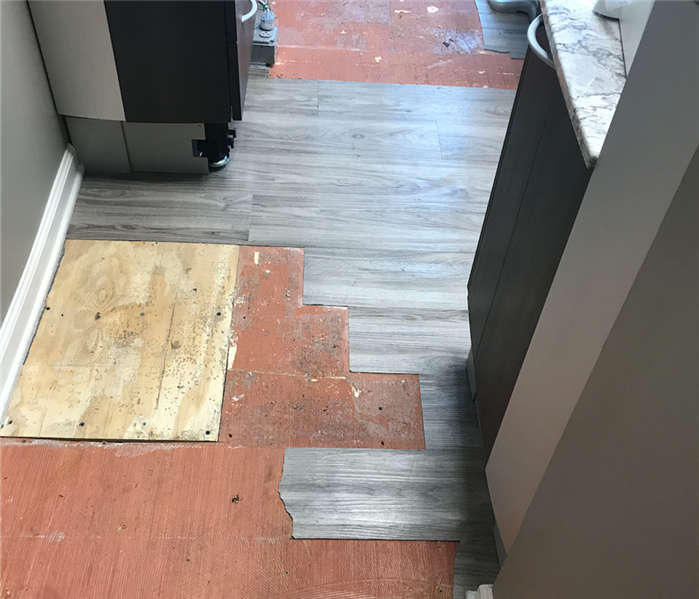 Vinyl flooring that faced water damage and has missing sections that were wet.