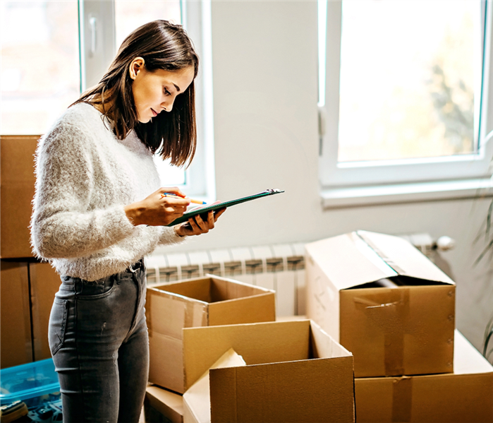 Woman checking her moving list.