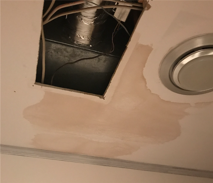 Water damage on ceiling causing discoloration at local business.